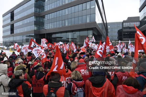 Employees of French multinational retailer Carrefour, holding Force Ouvriere union flags, demonstrate outside the Carrefour headquarters in Massy,...