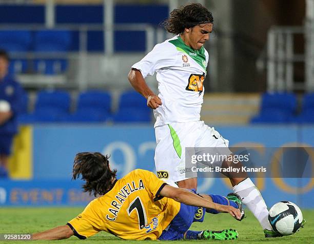 Zenon Caravella of the Gold Coast tackles David Williams of the Fury during the round 13 A-League match between Gold Coast United and Perth Glory at...