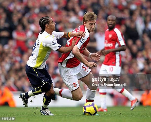 Nicklas Bendtner of Arsenal is challenged by Benoit Assou-Ekotto of Tottenham Hotspur during the Barclays Premier League match between Arsenal and...