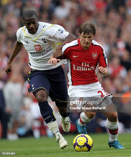 Andrey Arshavin of Arsenal is challenged by Sebastien Bassong of Tottenham Hotspur during the Barclays Premier League match between Arsenal and...