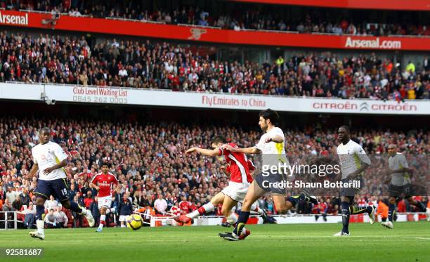 Cesc Fabregas of Arsenal scores the second goal during the Barclays Premier League match between Arsenal and Tottenham Hotspur at the Emirates...
