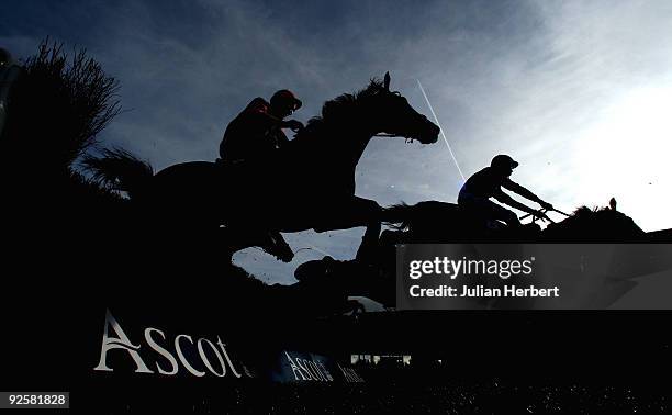 Liam Treadwell and The Last Derby clear tan early fence efore landing The United House Gold Cup Handicap Steeple Chase Race run at Ascot Racecourse...