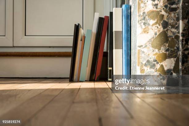 art books on a wood floor, nancy, france - stéréotype de la classe moyenne photos et images de collection