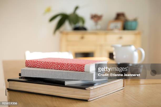 art books on a wood table, nancy, france - book table stock pictures, royalty-free photos & images