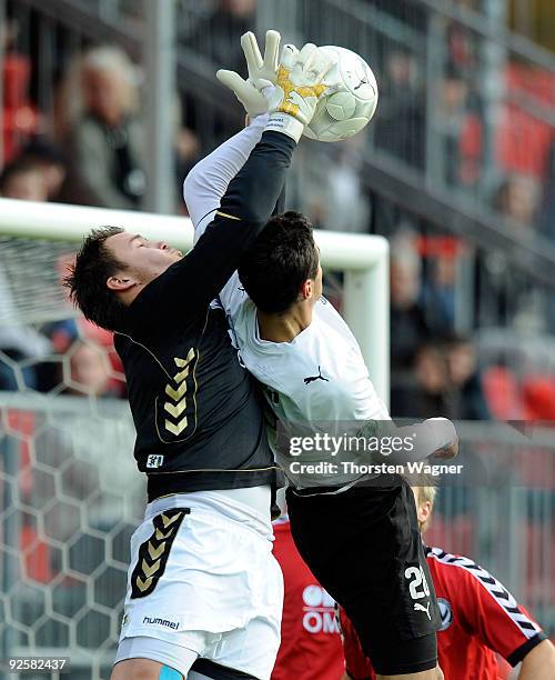 Alexander Eberlein of Sandhausen battles for the ball with goal keeper Manuel Riemann of Burghausen during the 3. Liga match between SV Sandhausen...