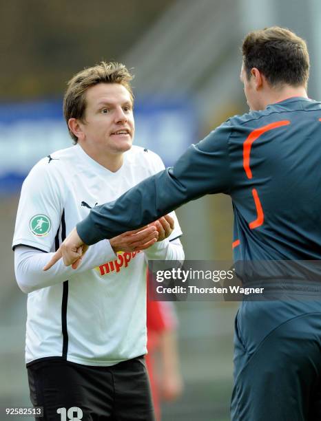 Regis Dorn of Sandhausen argues with referee Malte Dittrich pitch after been sent off and booked red card by him during the 3. Liga match between SV...