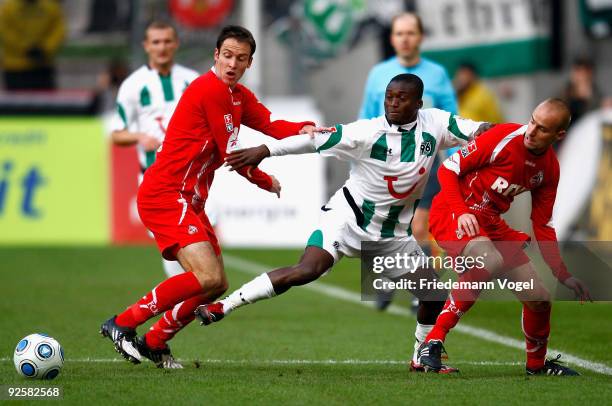 Sebastian Freis and Miso Brecko of Koeln in action with Constant Djakpa of Hannover during the Bundesliga match between 1. FC Koeln and Hannover 96...