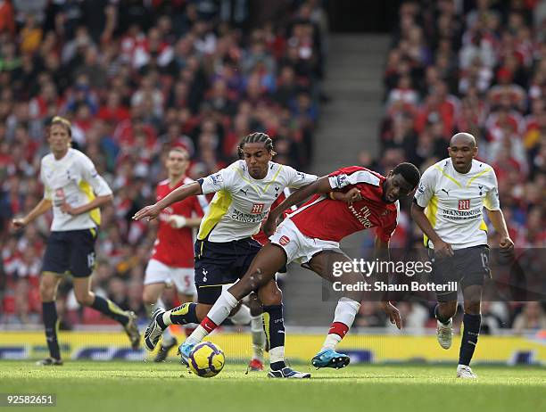 Benoit Assou-Ekotto of Tottenham Hotspur is challenged by Abou Diaby of Arsenal during the Barclays Premier League match between Arsenal and...