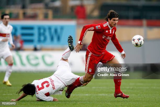 Mario Gomez of Muenchen goes past Serdar Tasci of Stuttgart during the Bundesliga match between VfB Stuttgart and Bayern Muenchen at the...