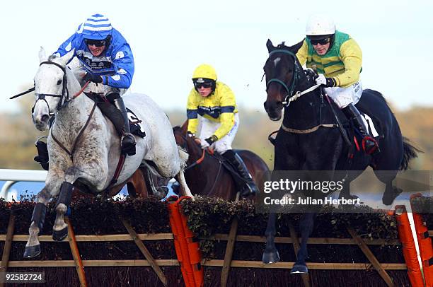 Dani's Girl and Peter Toole lead the Liam Treadwell ridden Pascha Bere over the last flight before landing The williamhill.com Handicap Hurdle Race...