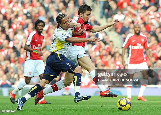 Arsenal's Spanish midfielder Cesc Fabregas vies with Tottenham's French Cameroonian defender Benoit Assou-Ekotto as Arsenal's Cameroonian defender...