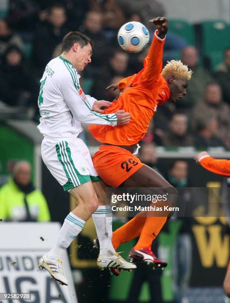 Marcel Schaefer of Wolfsburg and Aristide Bance of Mainz jump for a header during the Bundesliga match between VFL Wolfsburg and FSV Mainz 05 at the...