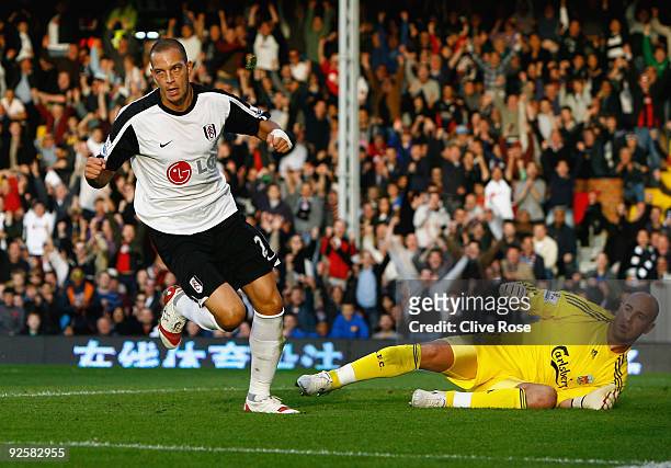 Bobby Zamora of Fulham celebrates his goal as Pepe Reina of Liverpool looks on during the Barclays Premier League match between Fulham and Liverpool...