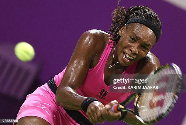Venus Williams of the US returns the ball to Serbia's Jelena Jankovic during their WTA Championships semi-final tennis match at the Khalifa...