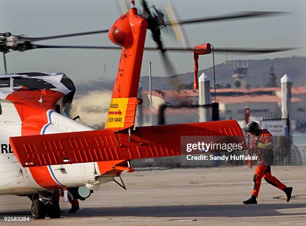 Coast Guard personnel depart on a search and rescue mission after a collision between a Marine Corps AH-1W Super Cobra helicopter and a Coast Guard...