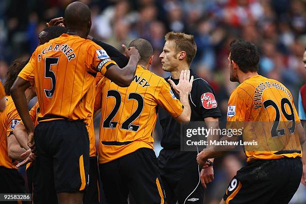 Hull City players complain to referee Michael Jones, after a penalty is awarded to Burnley during the Barclays Premier League match between Burnley...