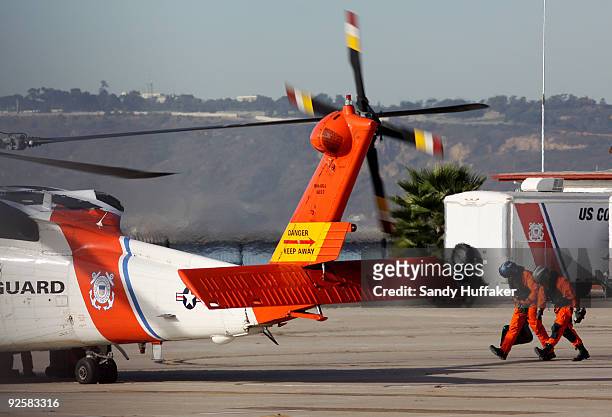 Coast Guard personnel depart on a search and rescue mission after a collision between a Marine Corps AH-1W Super Cobra helicopter and a Coast Guard...