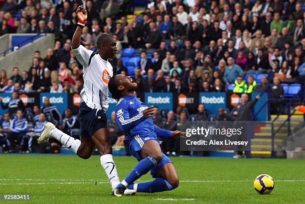 Jlloyd Samuel of Bolton Wanderers brings down Didier Drogba of Chelsea to concede a penalty during the Barclays Premier League match between Bolton...