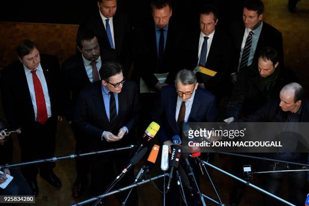 The head of the Parliamentary Control Panel Armin Schuster talks to journalists next to Green party's MP, Konstantin von Notz after a meeting with...