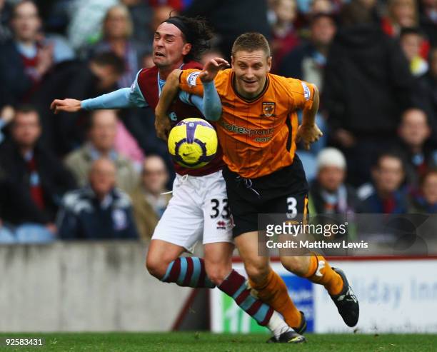 Andy Dawson of Hull City and Chris Eagles of Burnley challenge for the ball during the Barclays Premier League match between Burnley and Hull City at...