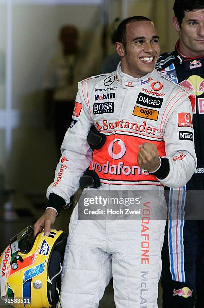 Lewis Hamilton of Great Britain and McLaren Mercedes celebrates in parc ferme after taking pole position during qualifying for the Abu Dhabi Formula...