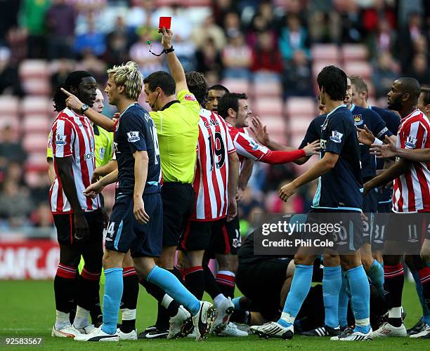 Kenwyne Jones of Sunderland gets a red Card from referee A Marriner after pushing Herita Ilunga of West Ham United during the Barclays Premier League...