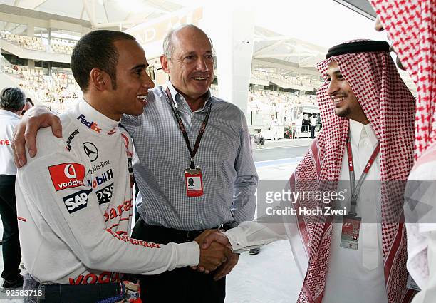 Lewis Hamilton of Great Britain and McLaren Mercedes celebrates with Ron Dennis , executive chairman of McLaren Automotive, and team guests after...