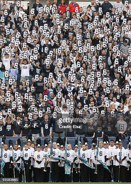 Fans hold up signs during a moment of silence to honor murdered player Jasper Howard of the Connecticut Huskies before the game against the Rutgers...