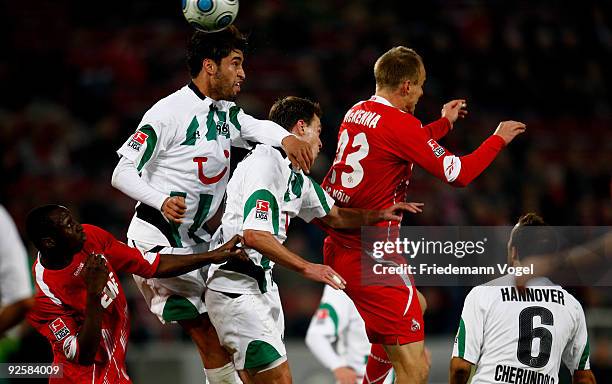 Manasseh Ishiaku and Kevin McKenna of Koeln in action with Karim Haggui and Hanno Balitsch of Hannover during the Bundesliga match between 1. FC...