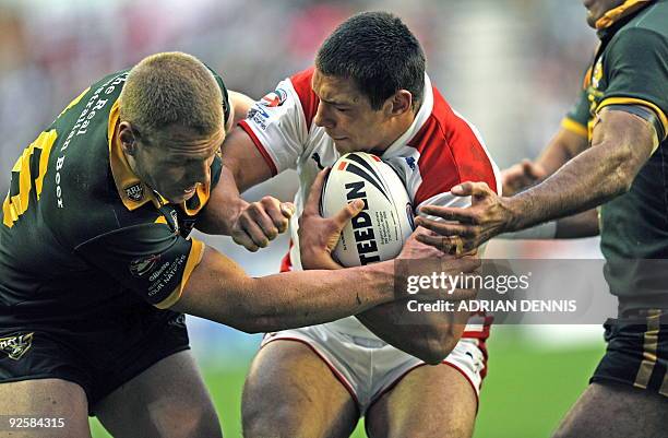 Australia's Utility Luke Lewis tackles England's Wing Ryan Hall during the Gillette Four Nations International Rugby League match at DW Stadium in...