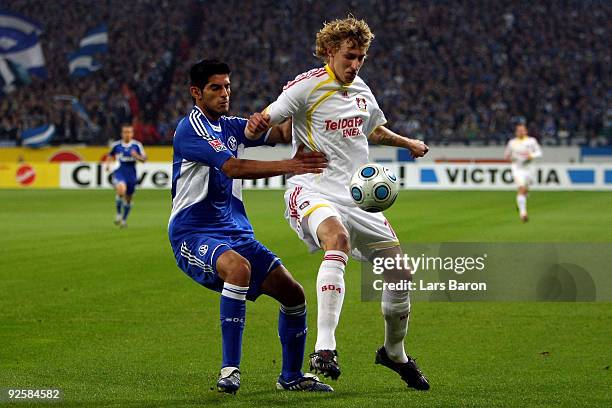 Carlos Zambrano of Schalke challenges Stefan Kiessling of Leverkusen during the Bundesliga match between FC Schalke 04 and Bayer 04 Leverkusen at the...