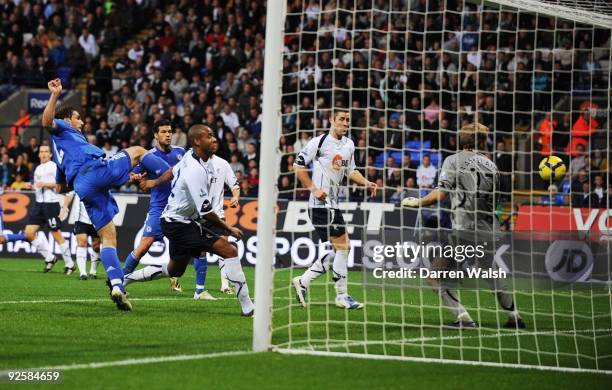 Zat Knight of Bolton scores an own goal against Bolton during the Barclays Premier League match between Bolton and Chelsea at the Reebok Stadium on...