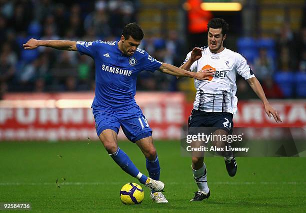 Michael Ballack of Chelsea holds off a challenge from Tamir Cohen of Bolton Wanderers during the Barclays Premier League match between Bolton...