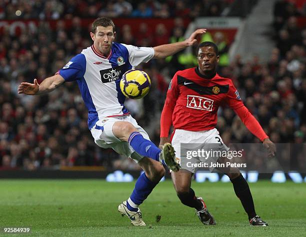 Patrice Evra of Manchester United clashes with Brett Emerton of Blackburn Rovers during the FA Barclays Premier League match between Manchester...