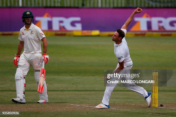 South Africa bowler Theunis de Bruyn is watched by Australian batsman Mitchell Marsh as he delivers a ball during play on the first day of the first...