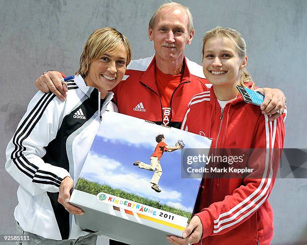 Britta Heidemann , Reinhard Heidemann and Sandra Minnert pose during a fencing cup at Kurt-Riess sports ground on October 31, 2009 in Leverkusen,...