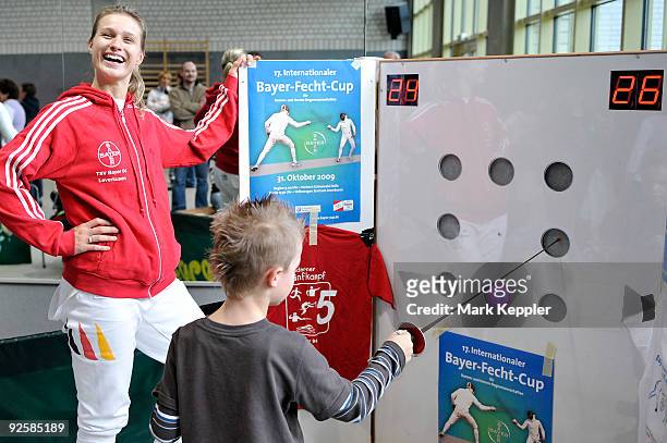 Britta Heidemann supports a young boy's training session during a fencing cup at Kurt-Riess sports ground on October 31, 2009 in Leverkusen, Germany.