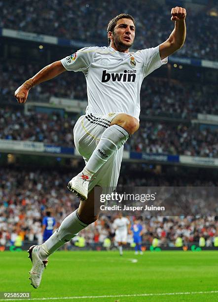 Gonzalo Higuain of Real Madrid celebrates scoring his sides opening goal during the La Liga match between Real Madrid and Getafe at Estadio Santiago...