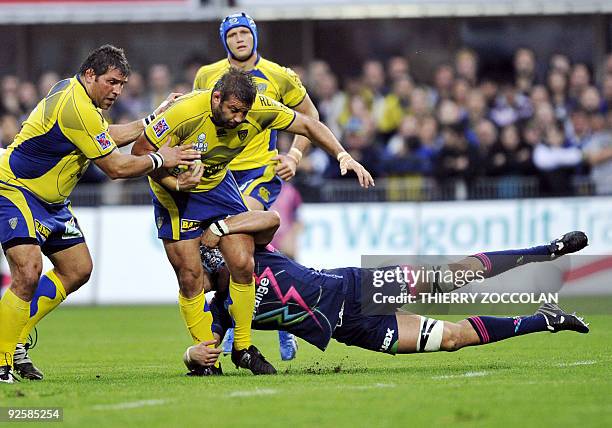 Clermont's French prop Lionel Faure is tackled by Stade Français English lockTom Palmer during the French Top 14 rugby union match Clermont vs. Paris...