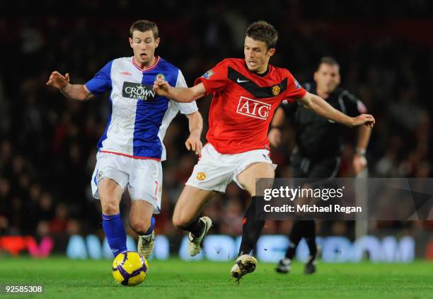 Michael Carrick of Manchester United is challenged by Brett Emerton of Blackburn during the Barclays Premier League match between Manchester United...