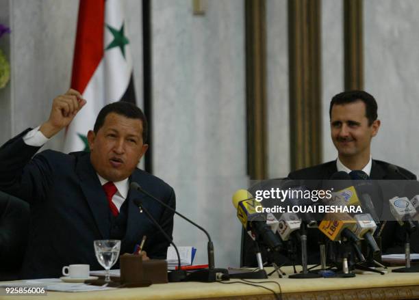 Syrian President Bashar al-Assad smiles as his Venezuelan counterpart Hugo Chavez speaks during a joint press conference held after their meeting in...