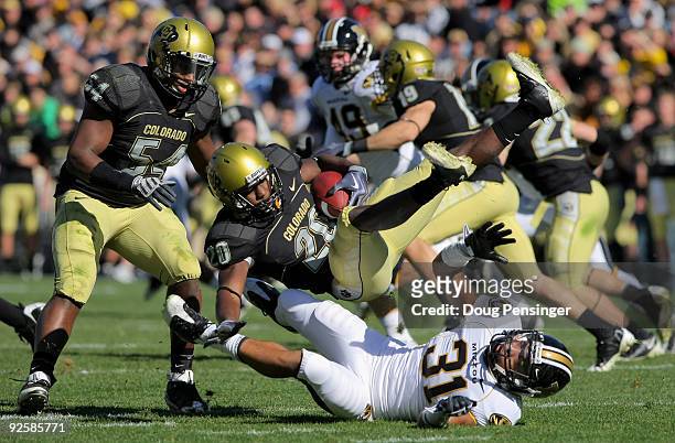 Brian Lockridge of the Colorado Buffaloes returns a kick off and is upended by Trey Hobson of the Missouri Tigers at Folsom Field on October 31, 2009...