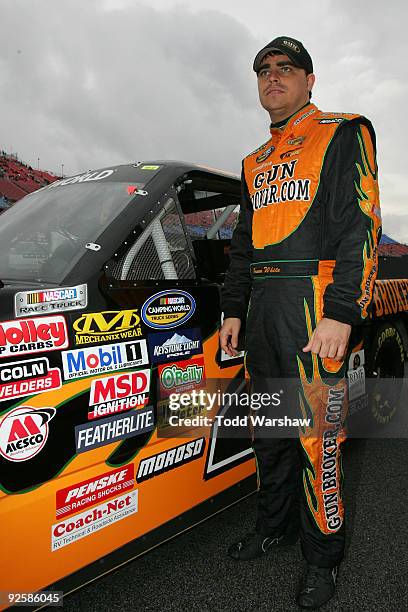 Jason White, driver of the GunBroker.com Dodge, waits by his car before the NASCAR Camping World Truck Series Mountain Dew 250 at Talladega...