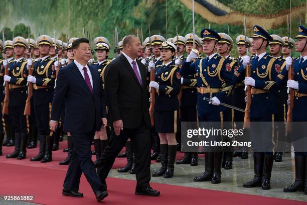 Chinese President Xi Jinping accompanies King Tupou VI to view an honour guard during a welcoming ceremony inside the Great Hall of the People on...