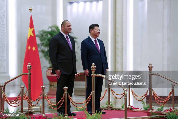 Chinese President Xi Jinping and King Tupou VI listen to their national anthems during a welcoming ceremony inside the Great Hall of the People on...