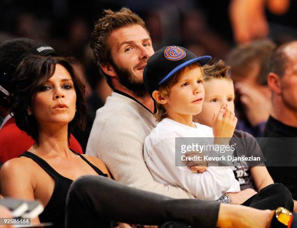 David Beckham and his wife Victoria follow the action between the Los Angeles Lakers and the Dallas Mavericks along with their children Cruz, left,...
