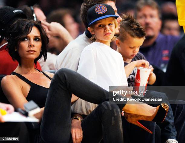 David Beckham and his wife Victoria follow the action between the Los Angeles Lakers and the Dallas Mavericks along with their children Cruz, left,...