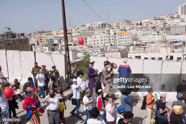 Israelis take part in a parade celebrating the Jewish holiday of Purim on March 1, 2018 in Hebron, West Bank. The carnival-like Purim holiday is...