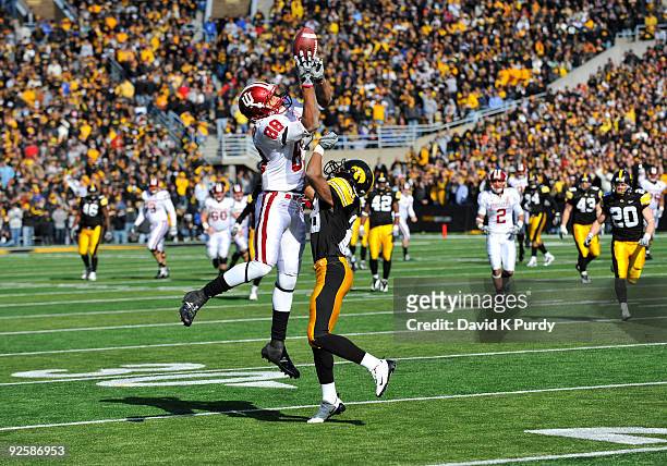 Defensive back Shaun Prater of the Iowa Hawkeyes defends as wide receiver Damarlo Belcher of the Indian Hoosiers catches a pass near the 20 yard line...