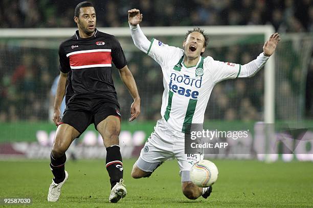 Andreas Granqvist of FC Groningen is tackled by Moussa Dembele of AZ Alkmaar, on October 31, 2009 during their Dutch first league match in Groningen....